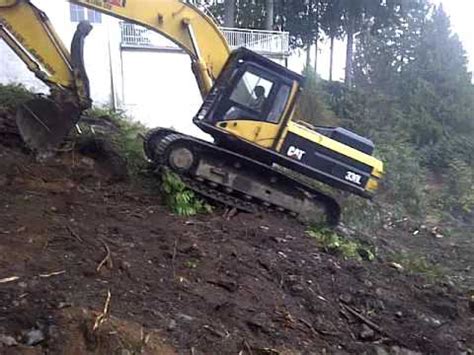 how to drive a mini excavator up a hill|mini ex drive up slope.